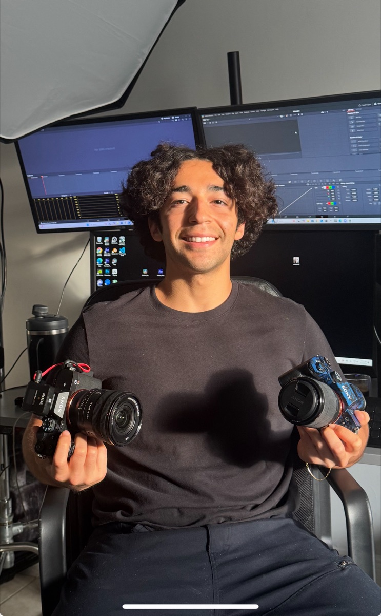 Kevin Consuegra in his studio holding two Sony cameras